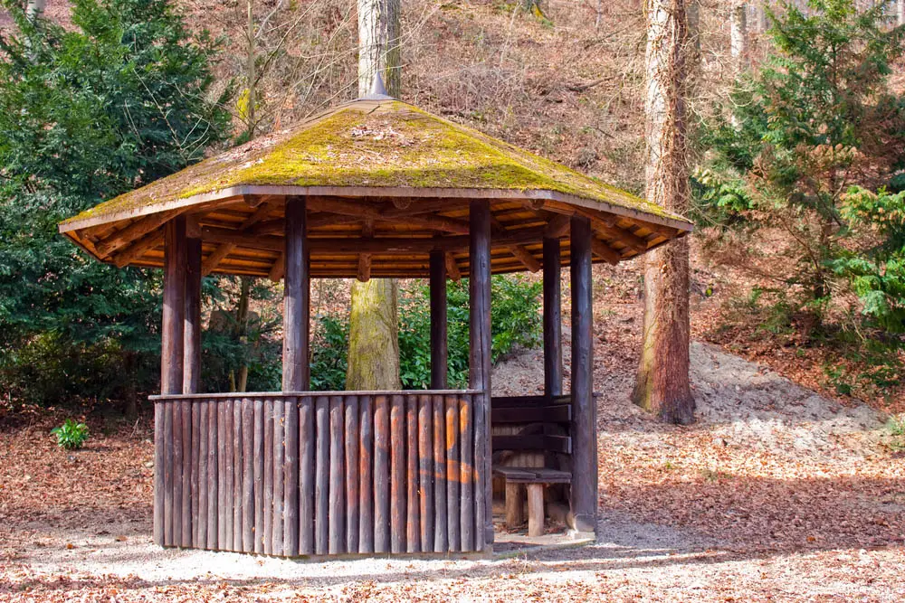 We've seen a couple rustic-styled gazebos already, but this model takes the cake. It's got a true log-cabin construction with natural log beams supporting a richly layered wood roof, sprinkled with moss on top. A structure like this could have been built any time in the past 300 years, and its timeless style is paired with a timeless usefulness. Built-in bench seats and a thick low wall add comfort and protection from the elements.