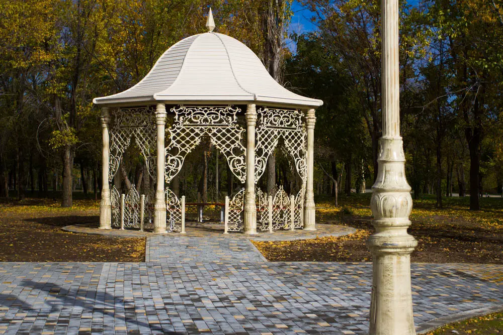 What stands out first, the bell roof or the ornate fencing? We can't decide, because this entire gazebo design has us transfixed. Standing atop a bespoke brick walkway, it's an extravagant, expertly crafted piece of art that just happens to provide shelter in the outdoors. This gazebo would work wonders in the backyard of any appropriately luxurious home or estate.