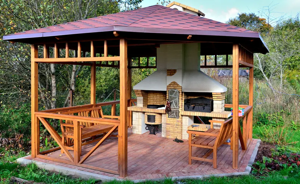 This might be our favorite gazebo yet. It's not only a handsome natural wood design with a subtle red roof and matching red brick foundation. This large gazebo features a large hearth and grilling station, perfect for outdoor family gatherings and cooking out. The large roof and twin bench seats provide plenty of shelter and comfort, while the large brick oven provides all the warmth and cooking possibilities you could ask for.