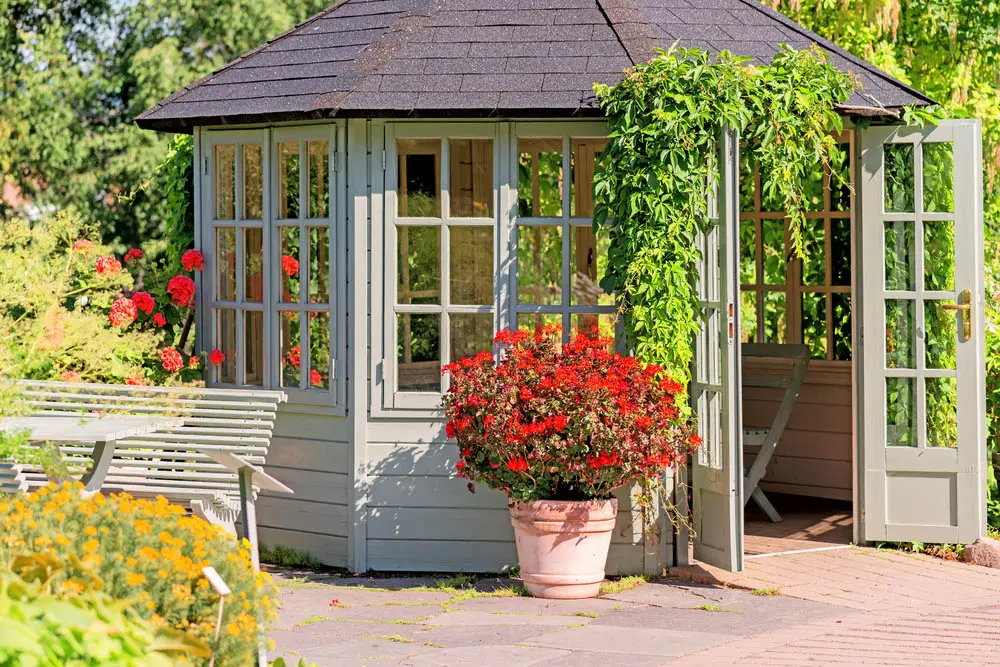 While most gazebos have a very open design, with simple pillars or a slow-slung fence denoting the boundaries of the structure, we occasionally find one as pictured above, with a mostly closed-in design that blocks wind and rain for those inside. The French door design is mirrored by the windows mounted all around, allowing it to be completely opened up or closed for comfort.