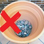 stones bottom of planter